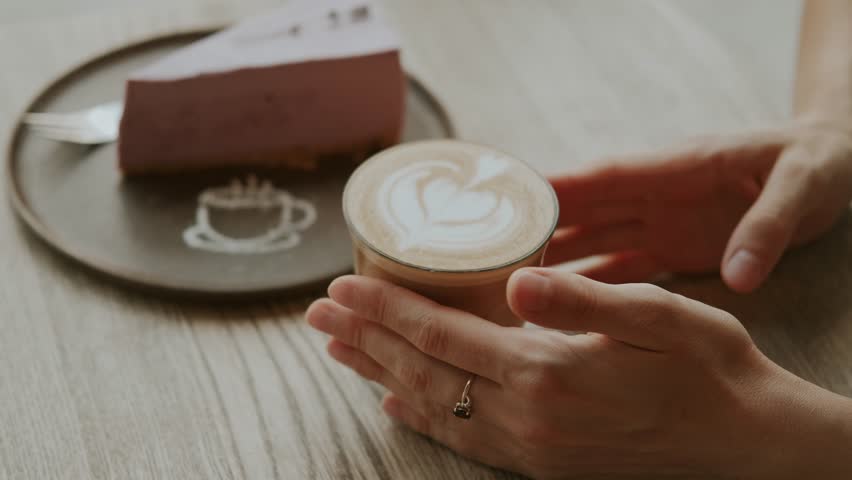 Savoring a Cozy Coffee Moment While Enjoying a Delicious Slice of Cake at the Charming Bistro