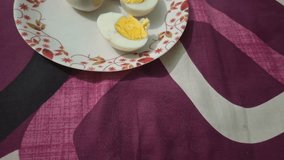 A boiled egg, perfectly cooked, reveals a smooth white exterior and a vibrant yellow yolk, neatly sliced for enjoyment. - Powered by Shutterstock - Get 15% off with code: PIKWIZARD15