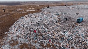 A vast landfill site filled with a mix of waste materials and junk sprawls across the landscape. The aerial view shows the extent of the litter and a vehicle parked nearby. - Powered by Shutterstock - Get 15% off with code: PIKWIZARD15