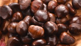 Chestnut, Fresh sweet chestnuts background, top view. Thanksgiving day. Edible chestnuts (Castanea sativa) pile over wood background, from above - Powered by Shutterstock - Get 15% off with code: PIKWIZARD15