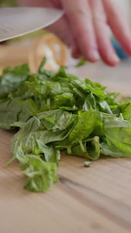 Chef Is Cutting Basil Leaves On A Wooden Cutting Board