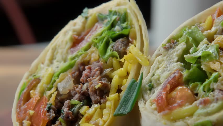 Green onions sprinkled on a burrito. Close-up. High quality 4k footage