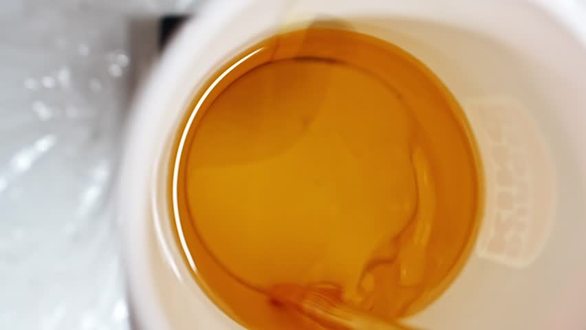 mixing perfume and melted wax to make scented candles. handiwork.