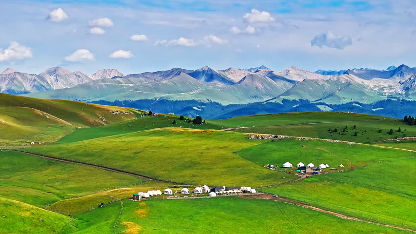 Green grass with mountain natural landscape in Kalajun grassland, Xinjiang. Kalajun Grassland is one of the most famous grasslands in China.