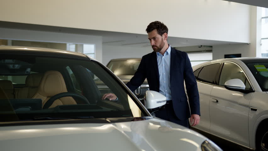 Caucasian man client buyer customer male businessman choosing modern electric car dealership guy choose luxury automobile auto salon showroom shopper vehicle purchase dream buy ownership driving store