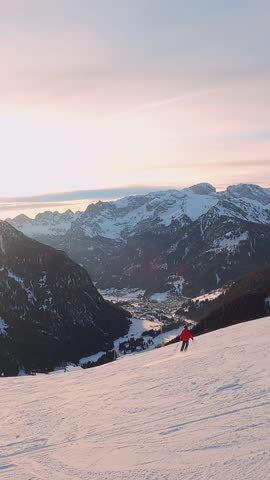 First-person view FPV first-person point of view POV of alpine skiing in Dolomites. Ski resort piste with people skiing in Dolomites in Italy. Ski area Belvedere. Canazei, Italy