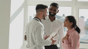 Doctor coming with good news to family couple. Indian female wife feeling excited happy about medical results tests. Doctor explaining results  of brain to couple, delivering good news - Powered by Shutterstock - Get 15% off with code: PIKWIZARD15