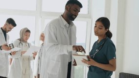 Indian doctors man and woman discussing. Global medicine, health, lifestyle and hospital concept. Multiethnic doctor and nurse talking about patient treatment  - Powered by Shutterstock - Get 15% off with code: PIKWIZARD15