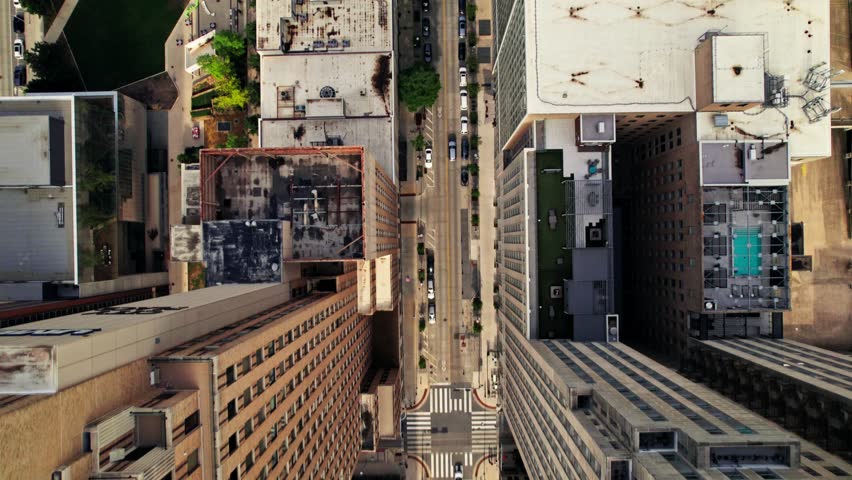 A bird's-eye view of an American city street. The drone flies between the houses. Summer day