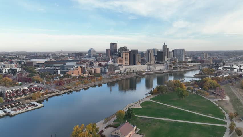 Drone footage capturing the St. Paul, Minnesota skyline with the Mississippi River in the foreground, highlighting autumn colors on a clear day