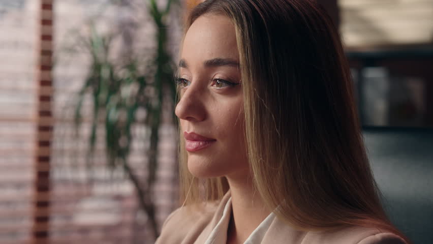 Close up gorgeous calm Caucasian specialist business woman leader boss female girl businesswoman office employee company manager worker secretary entrepreneur turning head looking at camera indoors