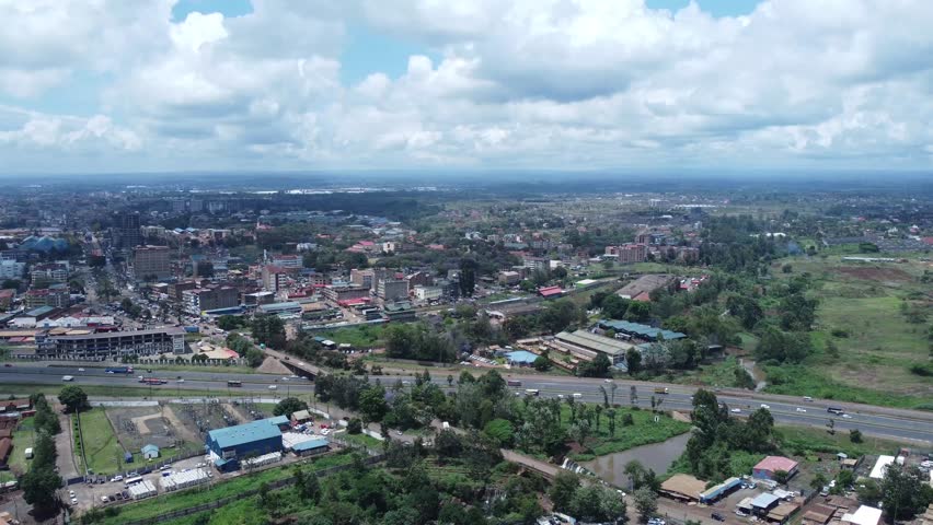 Ruiru, a suburb near nairobi with roads, buildings, and greenery under a cloudy sky, aerial view