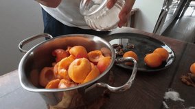 hands close up make a saucepan with apricots and sugar cooking apricot jam - Powered by Shutterstock - Get 15% off with code: PIKWIZARD15
