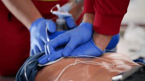 Hands of paramedic and doctor during resuscitation. Team of emergency medical service during CPR training on dummy. Themes rescue, urgency and health care.
 - Powered by Shutterstock - Get 15% off with code: PIKWIZARD15