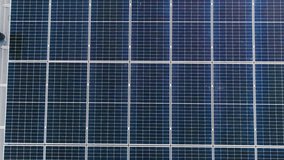 Photovoltaic solar panels on roof get clean energy from the sun. Slow motion. Aerial view. Solar Panel Array. Drone Aerial View of Modern Photovoltaic Electricity System, Close Up. - Powered by Shutterstock - Get 15% off with code: PIKWIZARD15