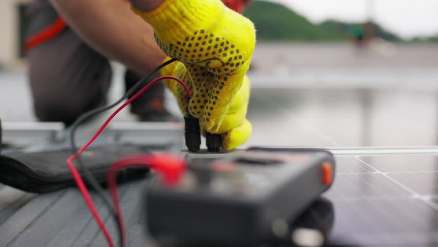 Close up, Solar energy specialist monitoring solar panels with his multimeter. Alternative, green energy worker. Energy engineer monitoring solar panels with his multimeter. Solar energy concept