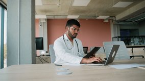 Pakistani doctor analyzing X-ray for diagnosis in clinic - Powered by Shutterstock - Get 15% off with code: PIKWIZARD15
