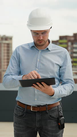 Builder Engineer Working with Digital Tablet on Construction Site