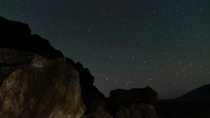 Timelapse of star trails over Native American petroglyphs in Eastern Sierra, California, USA