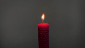 Single pink candle burning. Shot. Isolated on dark background candle burning. The match lights from candle. Concept of attention, mutual assistance and mentoring - Powered by Shutterstock - Get 15% off with code: PIKWIZARD15