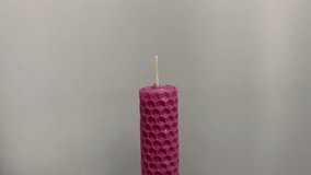Single pink candle burning. Shot. Isolated on white background candle burning. The match lights the candle, and then the match lights the candle. Concept of attention, mutual assistance and mentoring - Powered by Shutterstock - Get 15% off with code: PIKWIZARD15