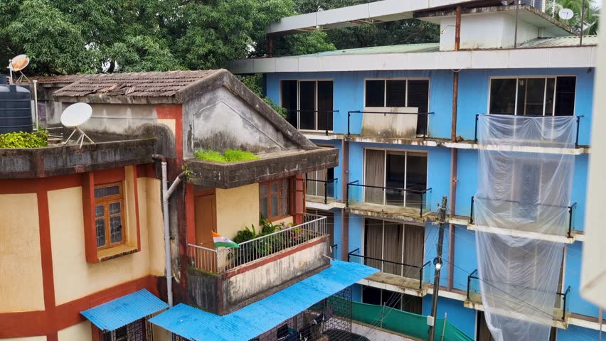 Old rural village town houses in goa bangalore, chennai pune under construction abandoned and flying the indian flag tricolor as a mark of respect on Independence day