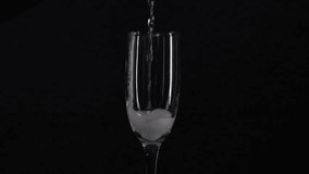 Champagne glass filling on black background - Powered by Shutterstock - Get 15% off with code: PIKWIZARD15