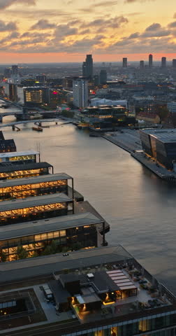 Aerial drone view of Borsen historical place in Copenhagen, Denmark at night. Vertical