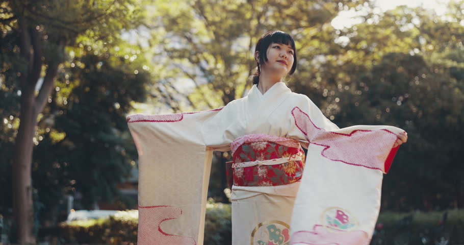 Woman, Japanese and dance outdoor in kimono for culture, history and traditional performance with elegance. Female person, moving and spiritual dancer in nature for heritage, art and garden in Japan