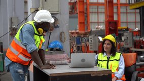 engineer manager or foreman woman sitting at table meeting with African American worker standing  discussion to working in industrial manufacturing factory. group of diversity engineer factory worker  - Powered by Shutterstock - Get 15% off with code: PIKWIZARD15