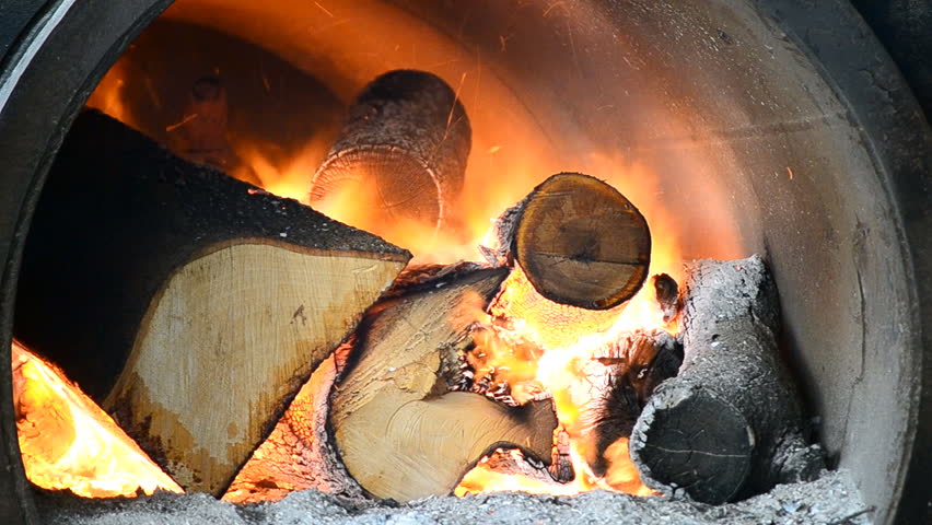 fire burning firewood in big stove