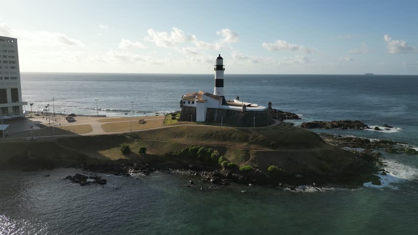 360 view of Farol da Barra, on the beach in Salvador, Bahia, during sunset and scenic Salvador coastline, Brazil