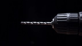 Rotating electric drill with on black background. Electric drill with a rotating bit, in hand. Construction concept - Powered by Shutterstock - Get 15% off with code: PIKWIZARD15