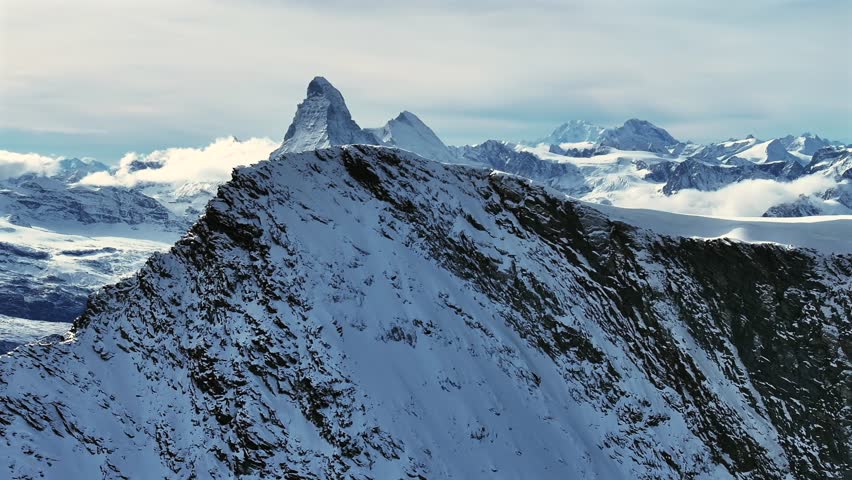 Matterhorn Zermatt Saas Fee Saastal Swiss Alps aerial drone glacier circle left reveal mountain peaks layer glacial glacier crevasse autumn fresh snow vista scenic landscape Gornergrat railway bluesky