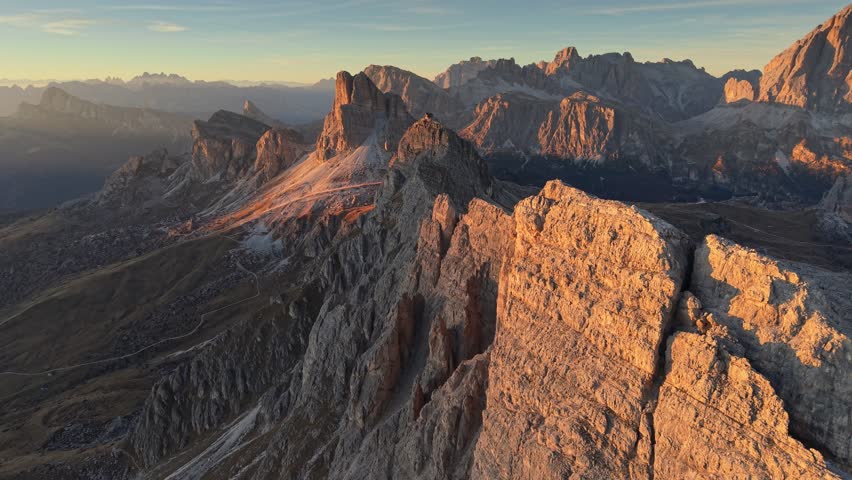 Breathtaking aerial view of the Dolomites in Italy, capturing rugged beauty of the mountains at sunset. Fly in Dolomites near Passo Giau - popular tourist destination