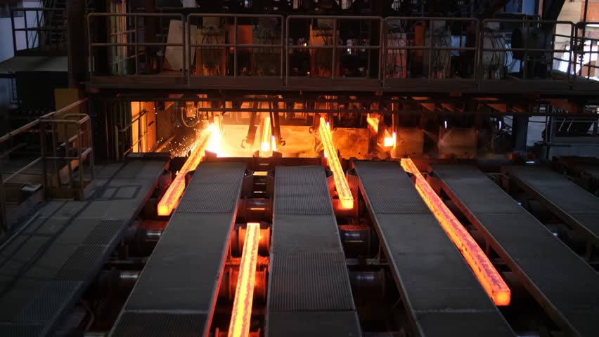 Steel Billets at Torch Cutting. Iron foundry. Continuous casting machine. Production of steel billets. Continuous casting machine with blow torch working. hot steel on conveyor in steel mill.