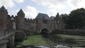 Koppelpoort gate with stone arches and water reflections in Amersfoort, Netherlands, daytime view, establishing pan - Powered by Shutterstock - Get 15% off with code: PIKWIZARD15