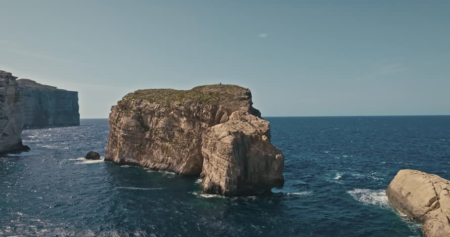 Aerial view of Fungus Rock on the Island of Gozo, Malta. Stony rocky coast of the Mediterranean Sea in the seascape of tourist Europe. High quality 4k footage