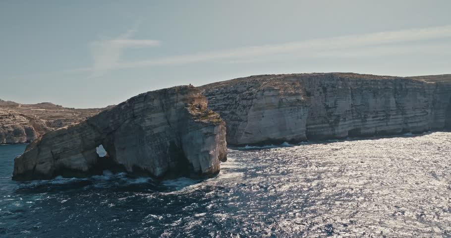 Aerial view of Fungus Rock on the Island of Gozo, Malta. Stony rocky coast of the Mediterranean Sea in the seascape of tourist Europe. High quality 4k footage