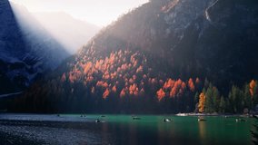 Lake Braies in Italy, scenic autumn landscape on an alpine lake in Italian Dolomites, sunset on Lago di Braies, row boats on the lake in the Dolomite Alps - Powered by Shutterstock - Get 15% off with code: PIKWIZARD15
