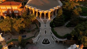 Park Guell aerial shot at sunrise, tourist landmark in Barcelona. Antonio Gaudi architecture. Dawn in Barcelona park Guell, Spain. High quality 4k footage - Powered by Shutterstock - Get 15% off with code: PIKWIZARD15