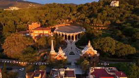 Revealing drone shot of Park Guell in Barcelona, aerial shot at sunrise, tourism in Barcelona. Antonio Gaudi architecture. Dawn in Barcelona park Guell, Spain. High quality 4k footage - Powered by Shutterstock - Get 15% off with code: PIKWIZARD15