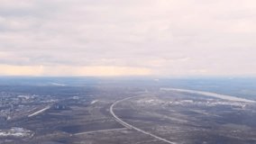 Aerial view of serene urban landscape under cloudy sky with sunbeams illuminating cityscape and river. - Powered by Shutterstock - Get 15% off with code: PIKWIZARD15