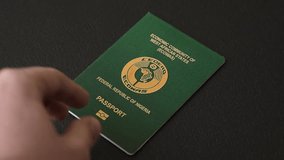 International passport of a citizen Nigeria on a dark concrete background, international travel - Powered by Shutterstock - Get 15% off with code: PIKWIZARD15