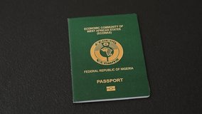 International passport of a citizen Nigeria on a dark concrete background, international travel - Powered by Shutterstock - Get 15% off with code: PIKWIZARD15