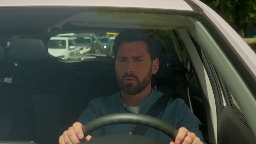 Caucasian man guy businessman driving car in city stuck traffic jam urban road transport problem accident angry aggressive mad furious male driver transport stressful drive automobile shouting scream
