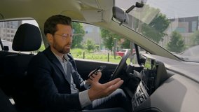 Business man inside modern electric car travel driving automobile in city displeased confused driver road destination auto navigation error worried using gadgets mobile phone gps app drive traffic jam - Powered by Shutterstock - Get 15% off with code: PIKWIZARD15