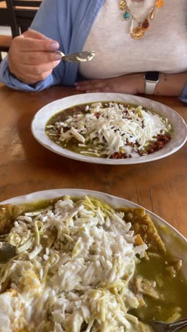 Woman Eating Chilaquiles with Chorizo