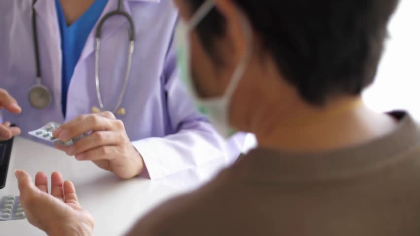 A doctor discussing medication with a patient in a clinical setting, emphasizing clear communication about drug usage, benefits, side effects, and proper dosage for effective care.