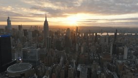 Aerial views capture the sunrise illuminating the New York City skyline, bathing iconic skyscrapers and busy streets in a warm glow, creating a stunning morning panorama - Powered by Shutterstock - Get 15% off with code: PIKWIZARD15